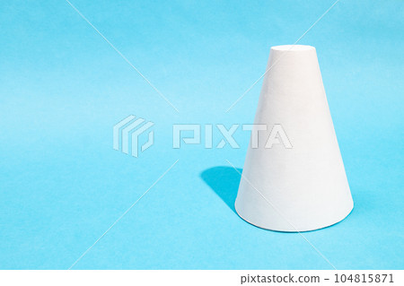 hand-crafted paper frustum cone on turquoise blue hand-crafted paper frustum cone on turquoise blue 104815871