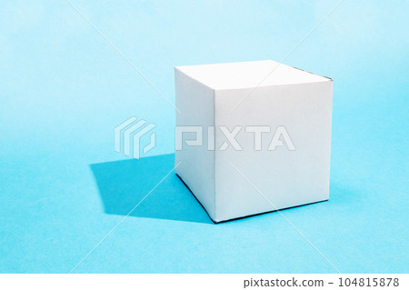 one hand-crafted paper cube on turquoise blue one hand-crafted paper cube on turquoise blue 104815878