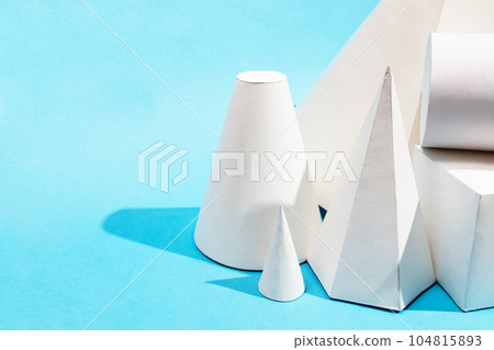 many hand-crafted paper geometric solids close up many hand-crafted paper geometric solids close up 104815893