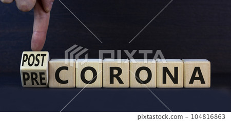 Covid-19 post or pre corona symbol. Turned wooden cubes and changed concept words Pre corona to Post corona. Beautiful grey background. Covid-19 pandemic post or pre corona concept. Copy space. Covid-19 post or pre corona symbol. Turned wooden cubes and changed concept words Pre corona to Post corona. Beautiful grey background. Covid-19 pandemic post or pre corona concept. Copy space. 104816863