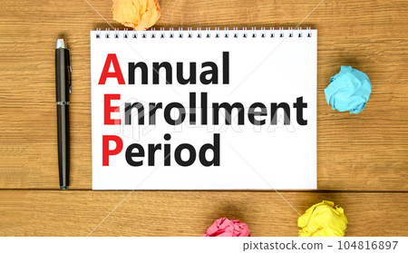 AEP symbol. Concept words AEP Annual enrollment period on beautiful white note. Beautiful wooden table wooden background. Medical and AEP Annual enrollment period concept. Copy space. 104816897