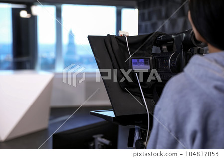 Professional video camera operator working in studio, closeup Professional video camera operator working in studio, closeup 104817053