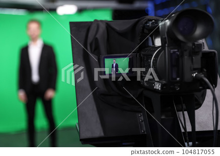 Presenter working in studio, focus on video camera screen Presenter working in studio, focus on video camera screen 104817055