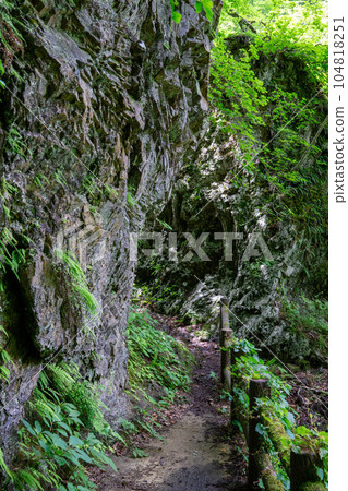 A straight road between huge rocks A straight road between huge rocks 104818251