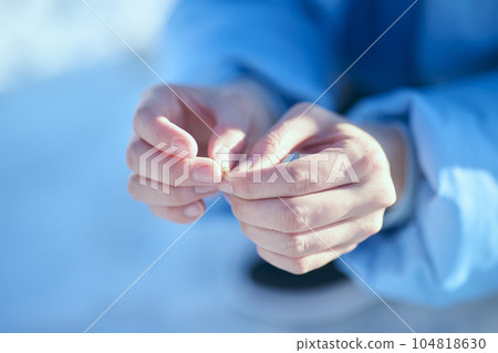A woman in her twenties fishing for smelt in a winter lake 104818630