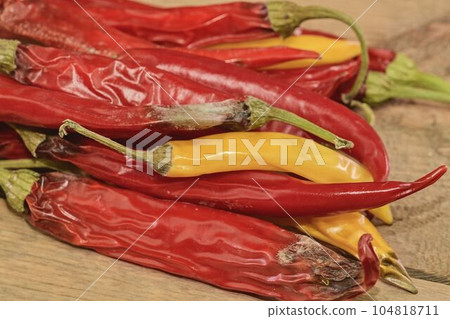 Shrinking and mould chili peppers on wooden background. Rotten chili peppers. Flat design Shrinking and mould chili peppers on wooden background. Rotten chili peppers. Flat design 104818711