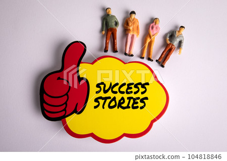 Success Stories Concept. Sticky note with text and miniature human figures on a white background 104818846