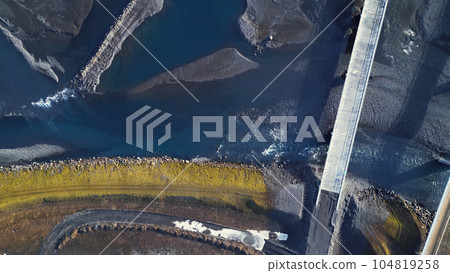 Aerial view of icelandic landscape and black fields, scandinavian scenery with frozen roads and lands in iceland. Beautiful panoramic view of nordic roadside, countryside. Slow motion. 104819258