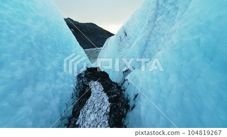 Aerial view of vatnajokull glacier crevasse, icelandic cracked ice blocks next to frozen lake in frosty landscape. Beautiful icebergs caves in iceland. Close up. Slow motion. 104819267