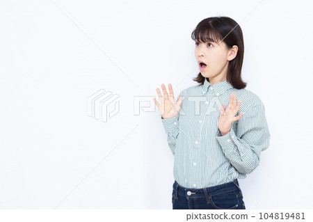 A woman in her thirties who is surprised in front of a white background A woman in her thirties who is surprised in front of a white background 104819481