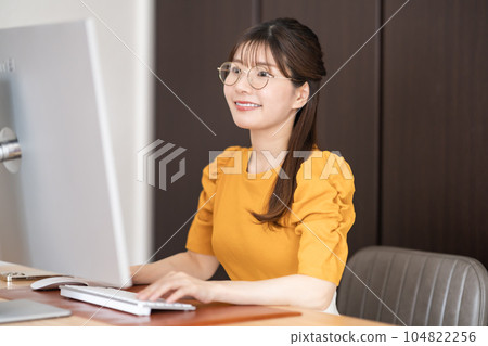 一名 20 多歲的女士戴著眼鏡進行遠程辦公 104822256