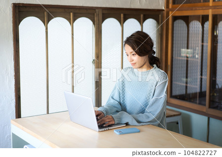 一位女士在咖啡館使用電腦 104822727