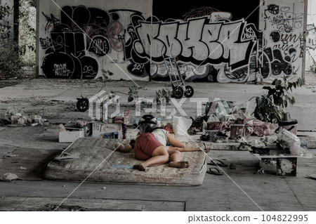 Homeless girl is sleeping in the abandoned building 104822995