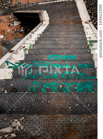 Top view of old metal staircase going down in the abandoned building and was left to deteriorate. Top view of old metal staircase going down in the abandoned building and was left to deteriorate. 104822998