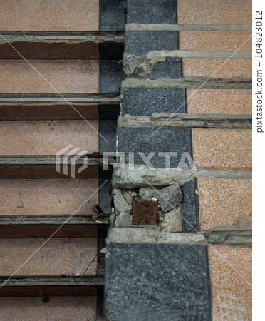View of The old cement staircase is in the abandoned building and was left to deteriorate over years. View of The old cement staircase is in the abandoned building and was left to deteriorate over years. 104823012
