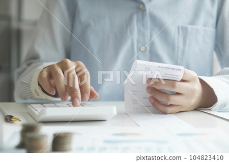 Accountant using calculator for calculate finance report in office Accountant using calculator for calculate finance report in office 104823410