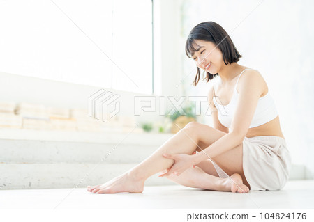 Women with leg skin care 104824176