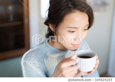 A woman drinking coffee A woman drinking coffee 104824203