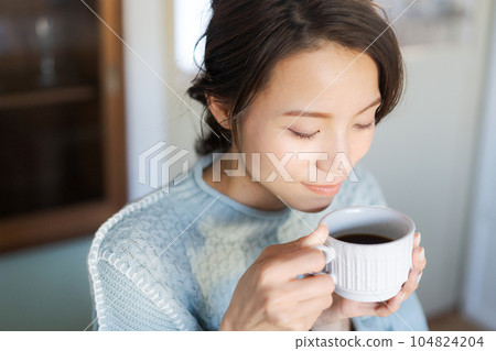 A woman drinking coffee A woman drinking coffee 104824204