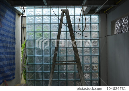 interior constuction site industry with glass block and steel ladder 104824781