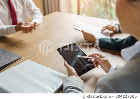 Examiner reading a resume during job interview at office Business and human resources concept Examiner reading a resume during job interview at office Business and human resources concept 104827500