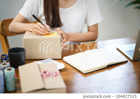 Business From Home Asian woman preparing package delivery box Shipping for shopping online. young start up small business owner at home online order Business From Home Asian woman preparing package delivery box Shipping for shopping online. young start up small business owner at home online order 104827525