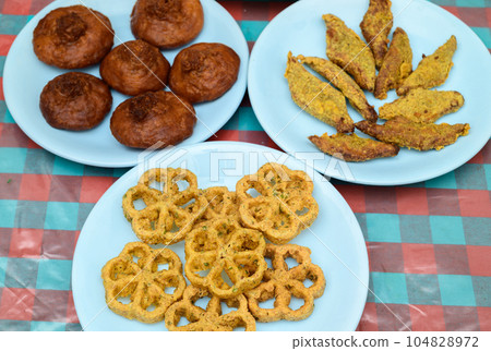 Sinhala and Tamil New Year celebration table with traditional sweets closeup overhead shot. Sinhala and Tamil New Year celebration table with traditional sweets closeup overhead shot. 104828972