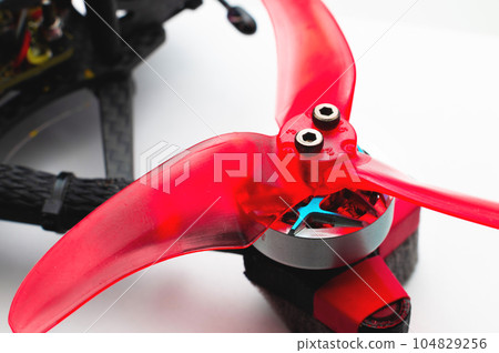 Closeup. propeller mounted on a brushless motor on the arm fpv quadcopter 104829256