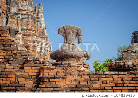 Broken ancient Buddha statue 104829430