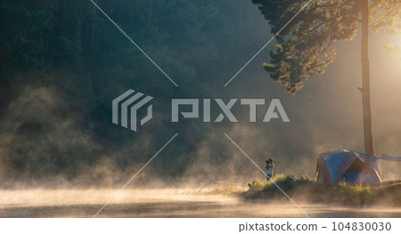 photographer takes pictures morning fog 104830030