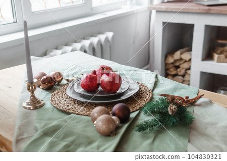 Serving a festive Christmas table in Scandinavian style. Decor on the table before the holiday. 104830321