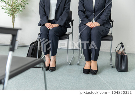 A woman interviewing in a suit A woman interviewing in a suit 104830331