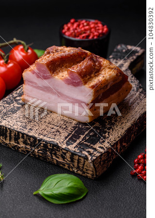 Delicious calorie smoked bacon with salt, spices and herbs Delicious calorie smoked bacon with salt, spices and herbs 104830392