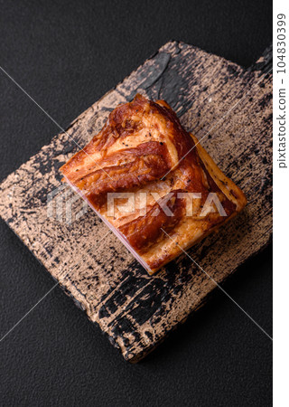 Delicious calorie smoked bacon with salt, spices and herbs 104830399
