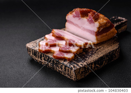 Delicious calorie smoked bacon with salt, spices and herbs 104830403