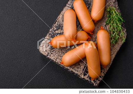 Delicious fresh boiled sausages with salt, spices and herbs Delicious fresh boiled sausages with salt, spices and herbs 104830433