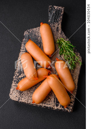 Delicious fresh boiled sausages with salt, spices and herbs Delicious fresh boiled sausages with salt, spices and herbs 104830434