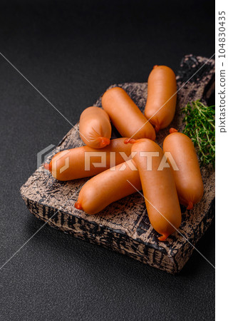 Delicious fresh boiled sausages with salt, spices and herbs 104830435