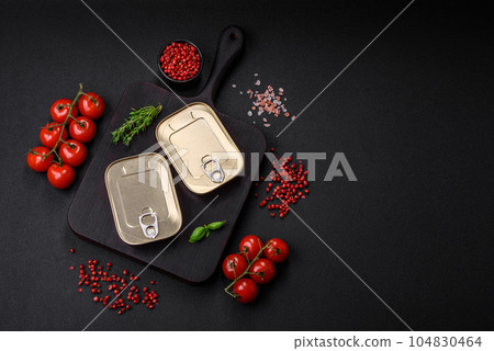 Tin or aluminum rectangular can of canned food with a key 104830464