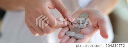 Closeup of woman counts coins in her hands. Closeup of woman counts coins in her hands. 104830752