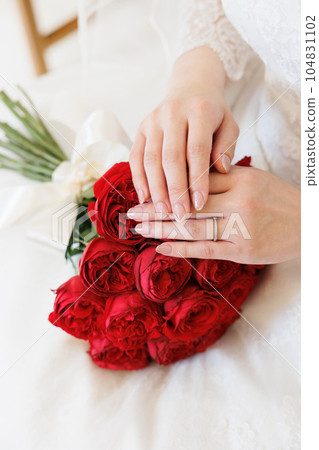 Image of a bride and a bouquet of red roses Image of a bride and a bouquet of red roses 104831102