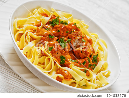 Creamy Paprika Pork Chunks over tagliatelle noodle Creamy Paprika Pork Chunks over tagliatelle noodle 104832576