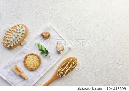 Cosmetic, massage and bath accessories set on white texture background 104832899