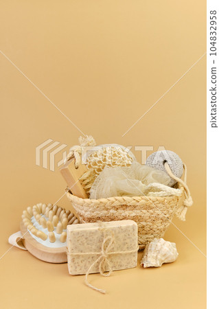 Bath accessories set in wicker basket on a beige background. 104832958