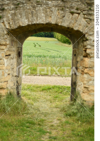 Fields and meadows through a historic wall, gate in Goslar Fields and meadows through a historic wall, gate in Goslar 104833210