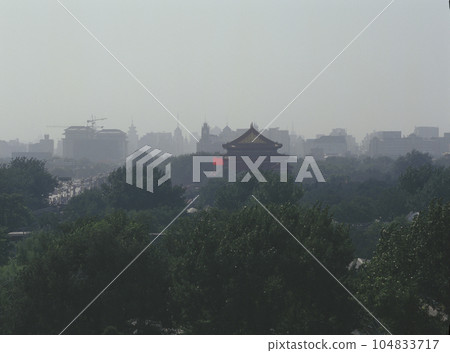 View of the roof of the Forbidden City and the Chinese flag from the hotel balcony View of the roof of the Forbidden City and the Chinese flag from the hotel balcony 104833717