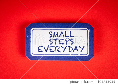 SMALL STEPS EVERYDAY. Sticky note with text on a red background SMALL STEPS EVERYDAY. Sticky note with text on a red background 104833935
