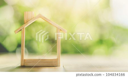 Wooden model house place on the table. concept of real estate investment. planning savings money of coins to buy a home concept for property. Wooden model house place on the table. concept of real estate investment. planning savings money of coins to buy a home concept for property. 104834166
