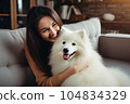 Cheerful woman hugging her beloved pet dog at home . Generative AI 104834329