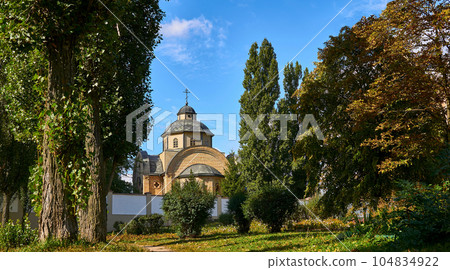 Christian church on a warm sunny day among green trees 104834922